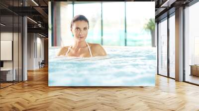 Beautiful woman relaxing in the jacuzzi Wall mural