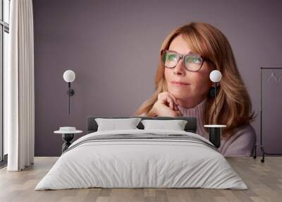 Close-up studio portrait of attractive middle aged woman Wall mural