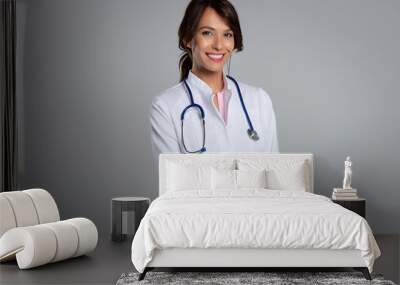 Studio portrait of middle aged female doctor against isolated background Wall mural