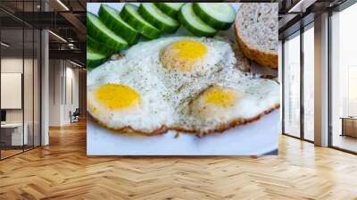 Close up of fried eggs vegetables and bread Wall mural