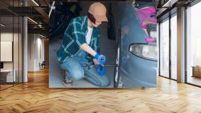 Female mechanic fixing car  in a garage Wall mural