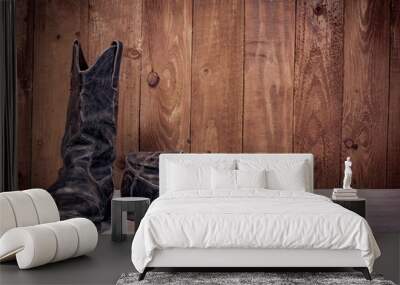 Old leather boots on dirt wooden background   Wall mural