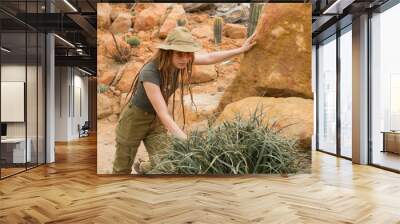 Young male traveler in desert, woman hiker in cactus garden Wall mural