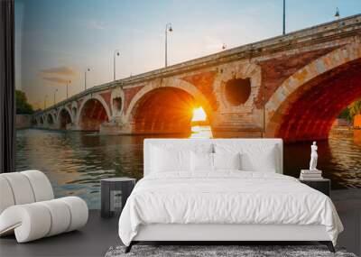 Medieval stone bridge Pont Neuf in Toulouse, France at sunset Wall mural