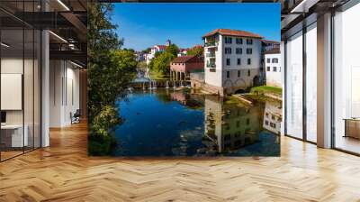 View of Saint-Palais in Pyrenees-Atlantiques departement and river Bidouze. French white town in Voie de Tours Chemin de Saint-Jaques Wall mural