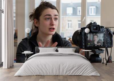 A woman records a video using a camera. AI. Wall mural