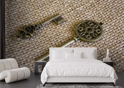 Two ancient bronze keys on burlap. Wall mural