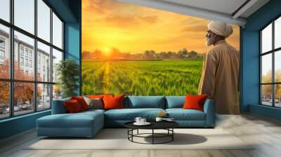 Elderly Punjabi Farmer Watching Sunset in Lush Green Field, Tranquil Scene Wall mural