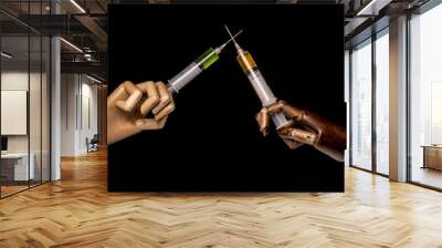 A syringe containing a green product is held by a white hand, another syringe held by a black hand. The hands are crossed. On black background. With copy-space. Wall mural