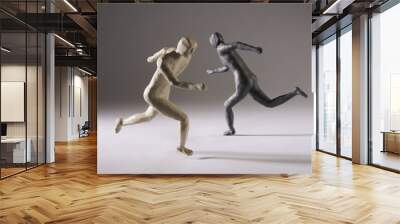 Black and white men run in different directions. With space copy  text. Isolated on grey background. Studio Shot. Wall mural