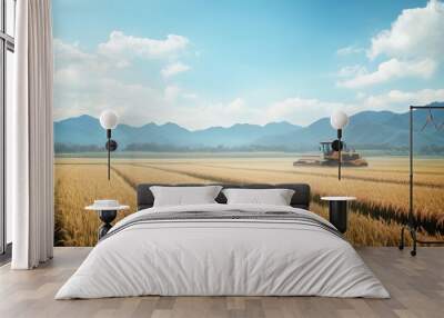 rice stalks being harvested in a large field, with a backdrop of mountains and blue skies.  Wall mural