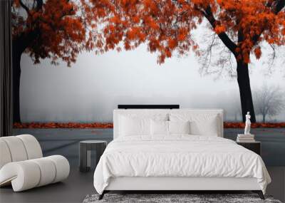 A bench is sitting in front of two trees with orange leaves Wall mural