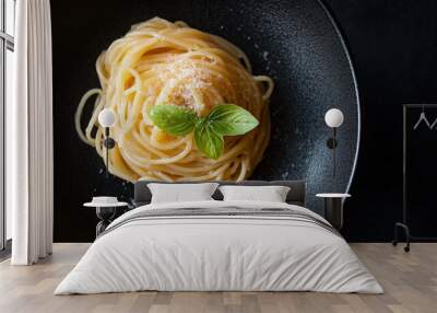 A plate of pasta with a green leaf on top Wall mural