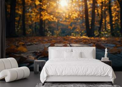 a wooden table with autumn leaves on it Wall mural