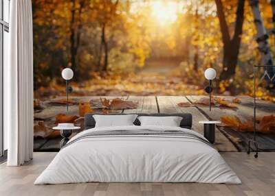 a wooden table with autumn leaves on it Wall mural