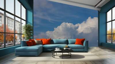 The sky is blue with a few clouds scattered throughout Wall mural