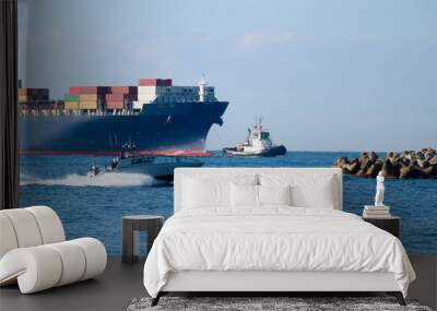 coast guard boat on high speed in mediterranean sea with big gargo container ship and tugboat on the Wall mural