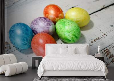 colorful easter eggs on wooden kitchen table close up Wall mural