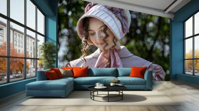 Young woman in vintage 19th century dress.holding a book Wall mural