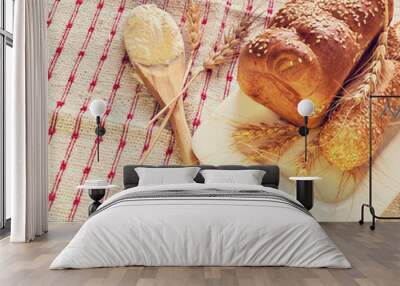 Composition with loaves of bread, ears of cereals and wooden spoon with white flour   Wall mural