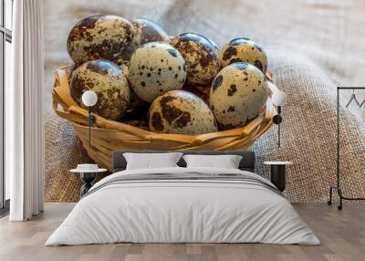 Wooden basket with quail eggs , all are on background with textured linen napkin Wall mural