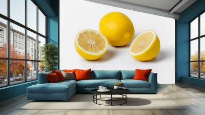 Three lemons are sitting on a white background. They are all yellow and appear to be fresh Wall mural