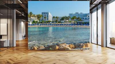 CYPRUS, VATHIA GONIA BEACH - MAY 12/2018: Tourists swim in the warm clear water of the Mediterranean Sea. Wall mural