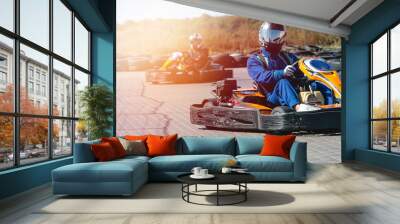 A driver in gear and helmet drives a racing car. In action. Go karts racing, sreet karting, rent. extreme sport. fun entertainment for drivers. Soft light glow, copy space Wall mural