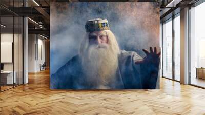 A grey-haired bearded and gloomy wizard in a gray cloak. Wall mural