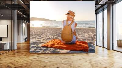 Beautiful woman on sunset beach. Summer vacation, sunny. Holiday travel. Relaxing. Wall mural