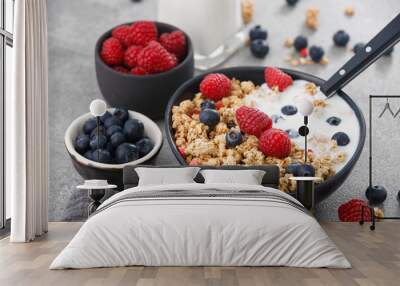 Cereal with berries and yogurt on stone background, close up. Healthy breakfast. Wall mural