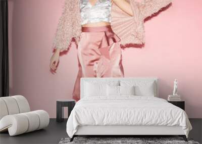 young fashion woman in pink clothes run on pink background; full lenght; front view Wall mural