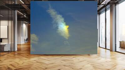 cloud illuminated by a ray of sun high in the sky Wall mural