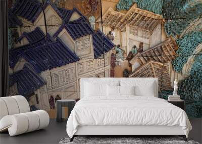 decorative clay tiles on the wall with the image of houses and people Wall mural