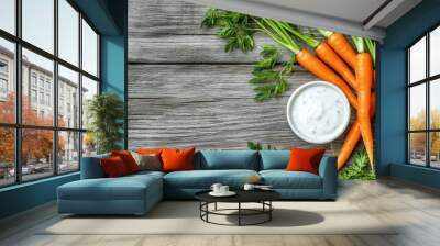 Fresh carrots with herbs dip on wooden background Wall mural