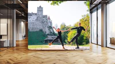 Happy young couple hugging kisses dancing, man and woman. Brasov, Transylvania. Romania. The medieval Castle of Bran. Travel and vacation to Europe, tour. beautiful sunny day, copy space Wall mural