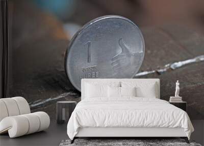 Indian rupee coin clamped in a metal grip. Concept of financial problems. Wall mural