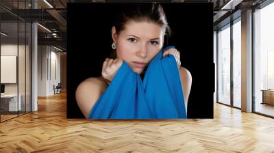 Portrait of the girl  wrapped up dark blue fabric on a black bac Wall mural