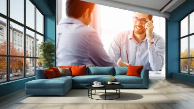 Attractive office worker sitting at desk Wall mural