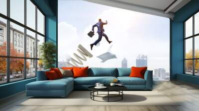 Businessman jumping on springboard . Mixed media Wall mural