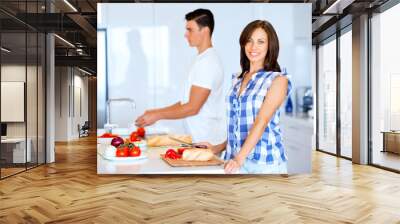 Couple cooking together at home Wall mural