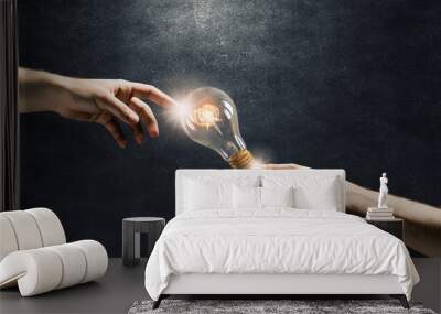 Hand pointing light bulb Wall mural