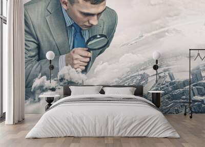 Man looking in magnifier Wall mural