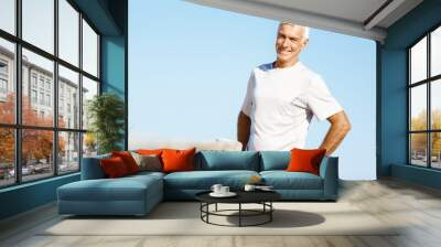 Man standing on beach in sports wear Wall mural