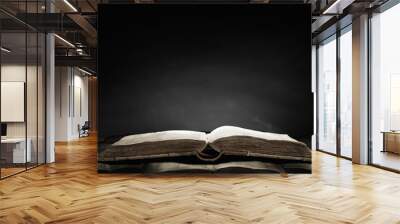 Old book in darkness Wall mural