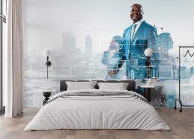 Smiling black businessman standing against a cityscape and graphic background Wall mural