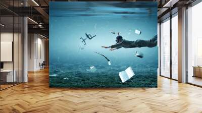 Young businessman in suit swimming Wall mural