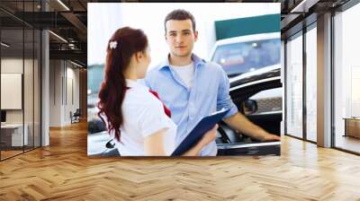 Young man at car salon Wall mural