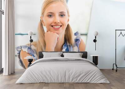 Young woman working in office Wall mural