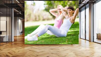 Young women exercising in the park Wall mural